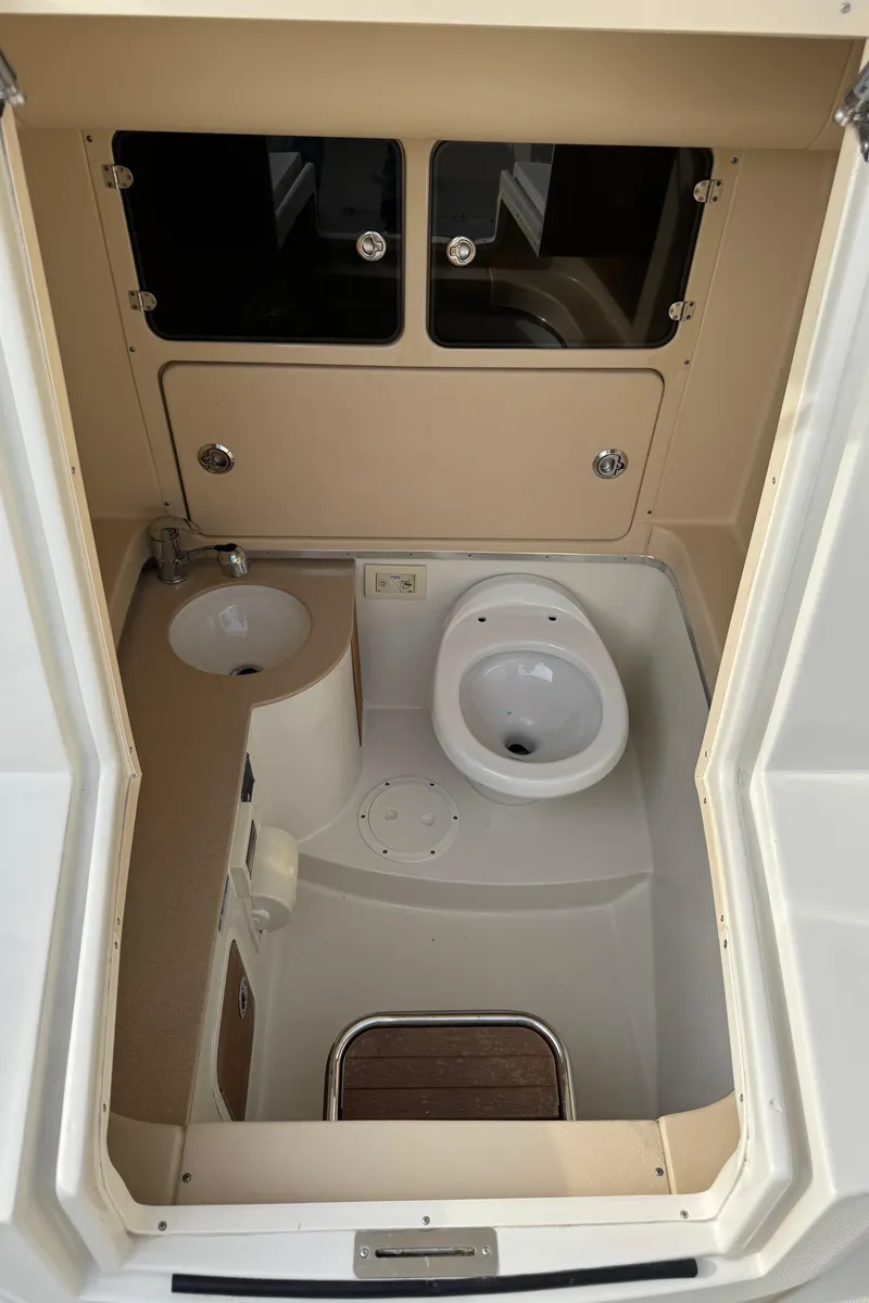 Slide: The Image of 2015 Chris-Craft Catalina 29 boat bathroom interior with sink and toilet. - 15