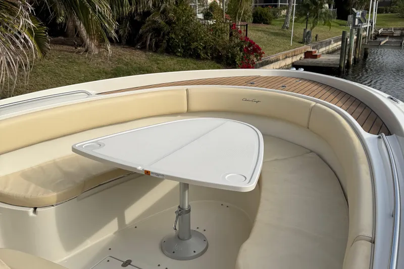 Slide: The Image of 2015 Chris-Craft Catalina 29 boat with cushioned seating and a triangular table. - 17