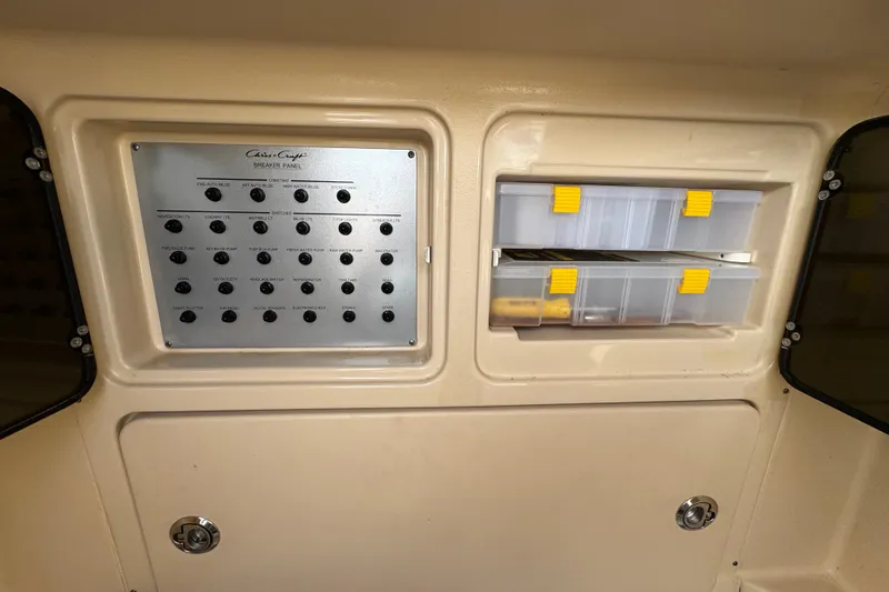 Slide: The Image of Control panel and storage compartments on a 2015 Chris-Craft Catalina 29 boat. - 25