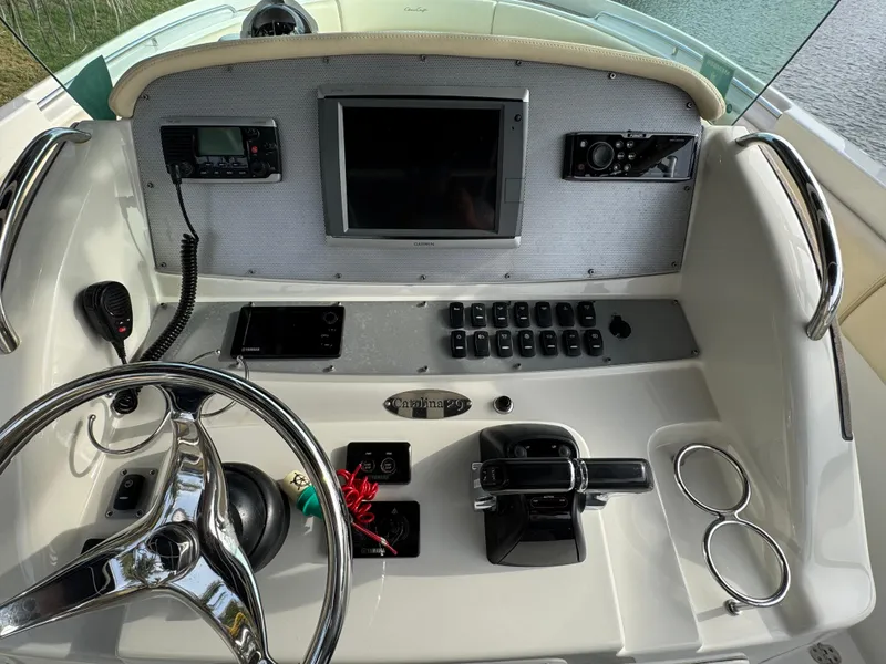 Slide: The Image of Helm of 2015 Chris-Craft Catalina 29 with steering wheel, controls, and navigation equipment. - 6