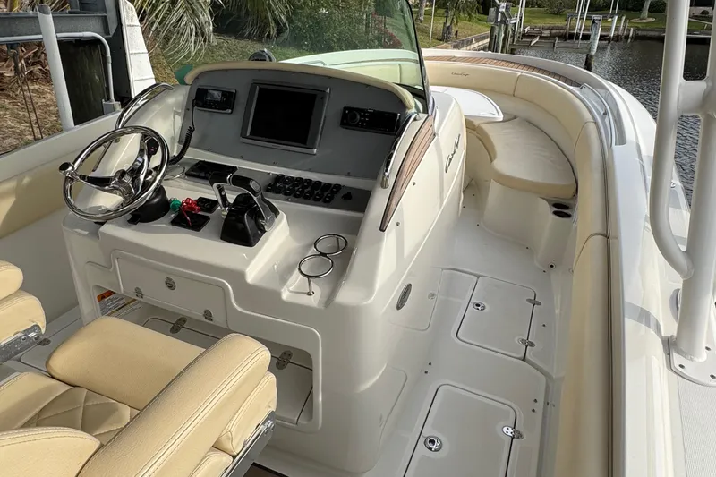 Slide: The Image of 2015 Chris-Craft Catalina 29 boat interior with helm, steering wheel, and seating. - 7