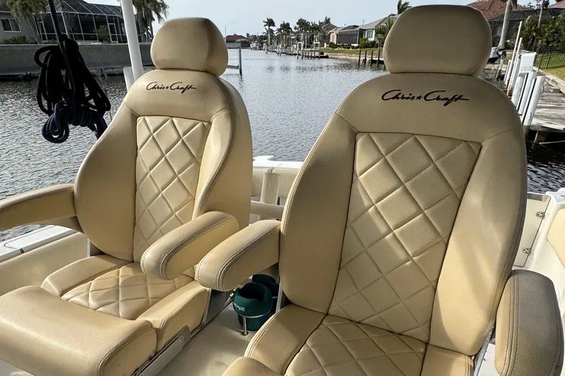 Slide: The Image of Luxurious beige seats on a 2015 Chris-Craft Catalina 29 boat by the water. - 9