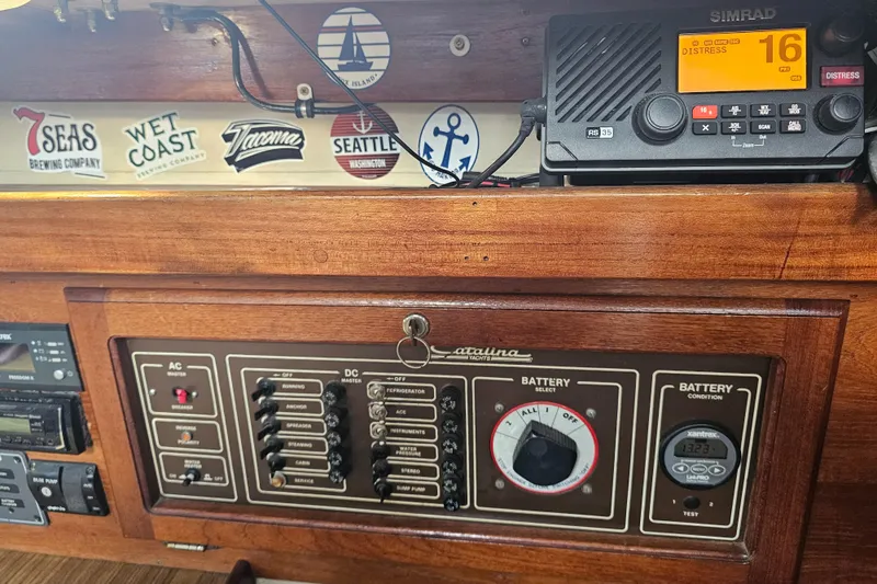 Slide: The Image of Electrical panel and radio on a 1986 Catalina 36 sailboat with nautical stickers. - 12
