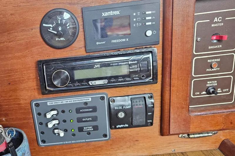 Slide: The Image of Control panel of a 1986 Catalina 36 sailboat with fuel gauge and electrical systems. - 13