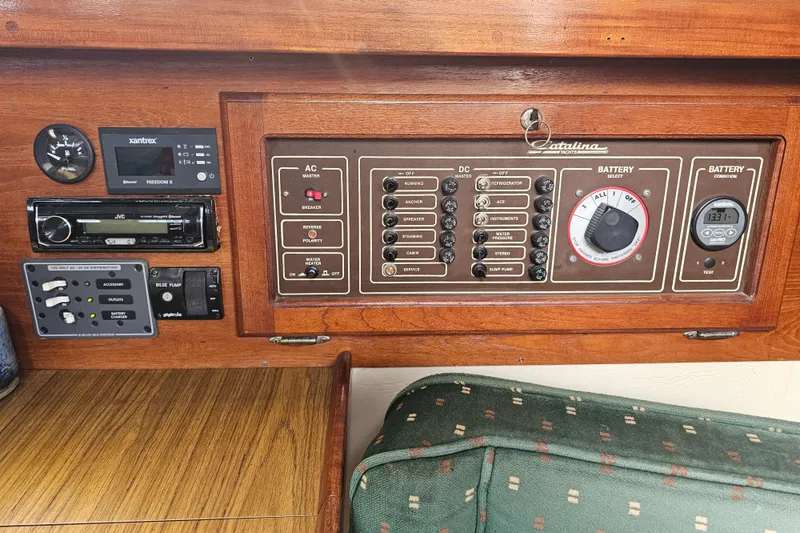 Slide: The Image of Control panel of a 1986 Catalina 36 sailboat with various switches and gauges. - 14