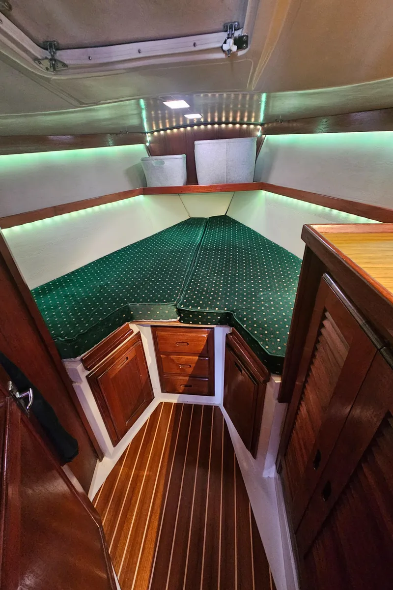 Slide: The Image of Interior of 1986 Catalina 36 sailboat with wood finish and green upholstery. - 16