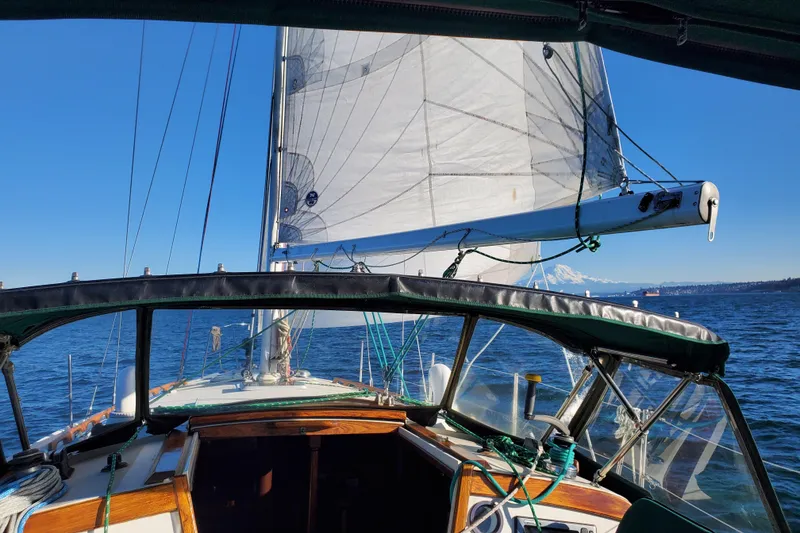 Slide: The Image of 1986 Catalina 36 sailboat on open water under clear blue skies. - 3