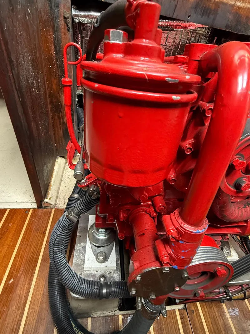 Slide: The Image of Red engine of a 1986 Catalina 36 sailboat, showcasing detailed mechanical components. - 31