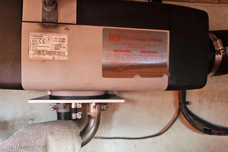 Slide: The Image of Catalina 36 (1986) engine component with warning labels and wiring. - 33