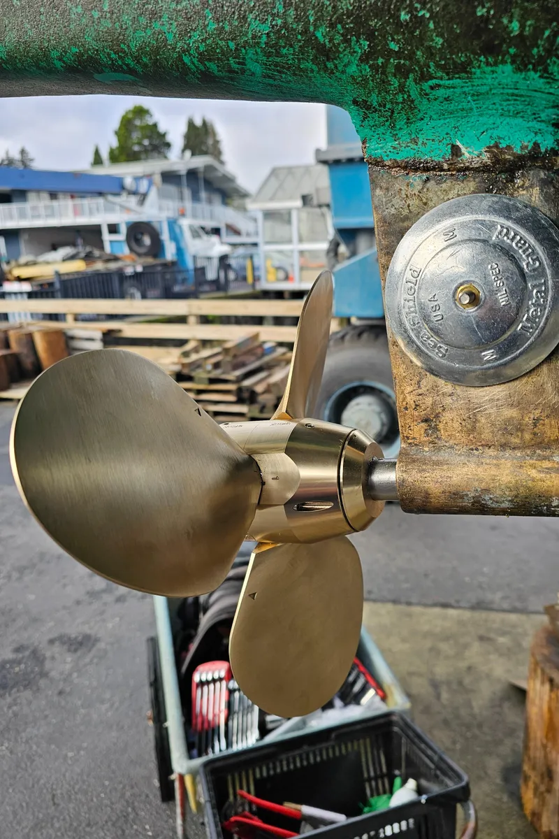 Slide: The Image of Catalina 36 (1986) boat propeller and zinc anode in a shipyard setting. - 35