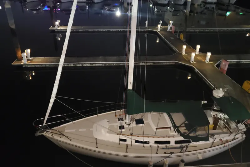 Slide: The Image of 1986 Catalina 36 sailboat docked at night in a marina. - 46