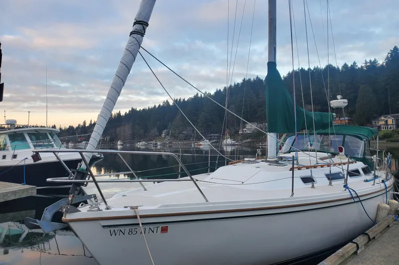 Slide: The Image of 1986 Catalina 36 sailboat docked in a serene marina setting. - 49