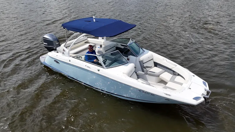 Slide: The Image of 2019 Cobalt 25 SC boat with Yamaha 300 engine on freshwater, blue canopy, and sleek design. - 10