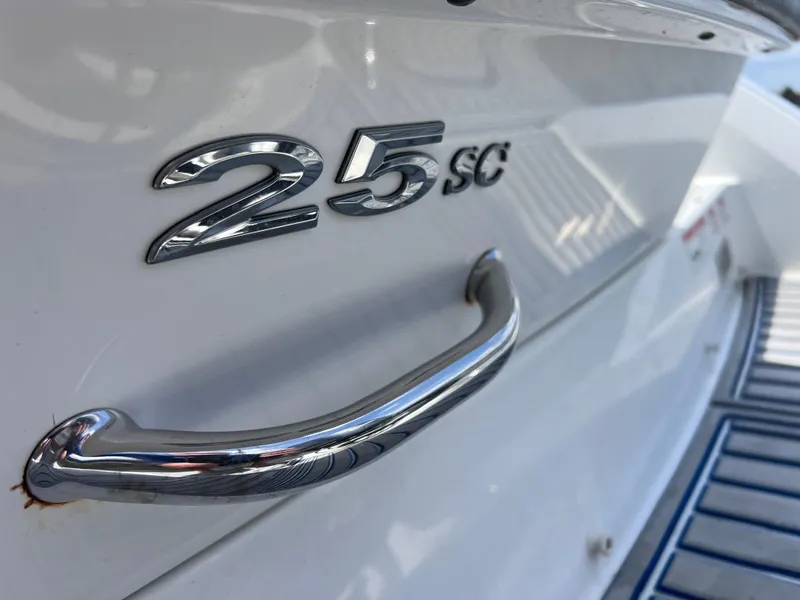 Slide: The Image of 2019 Cobalt 25 SC boat with chrome handle and model emblem. - 13