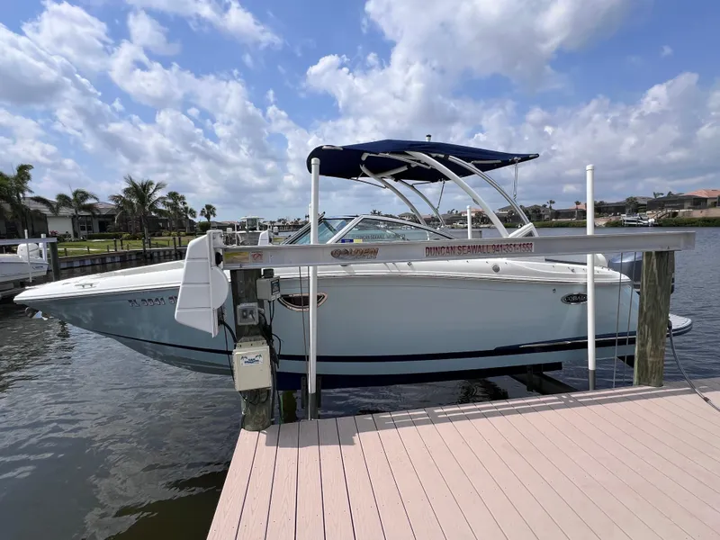 Slide: The Image of 2019 Cobalt 25 SC boat with Yamaha 300 engine docked on a sunny day. - 2