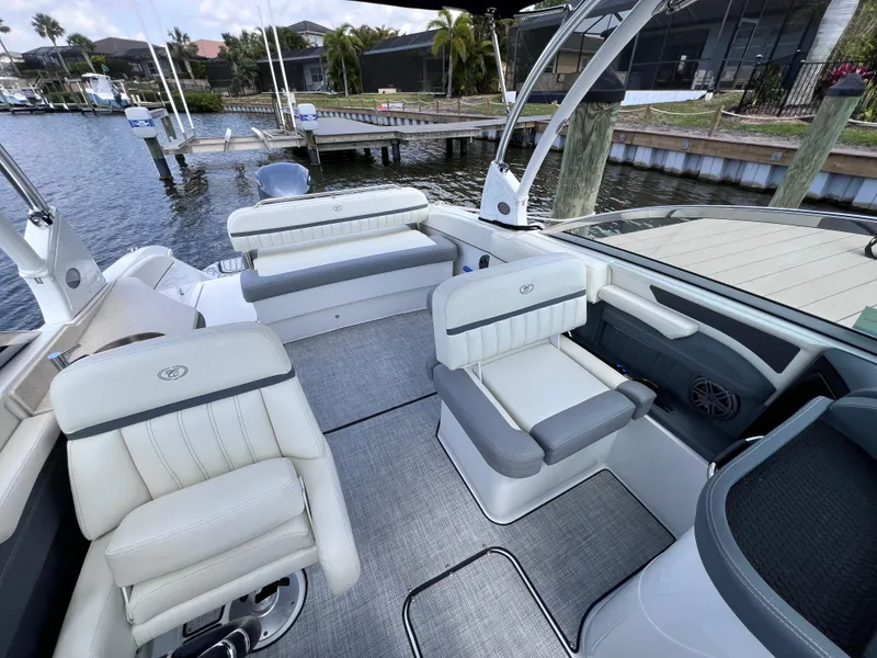 Slide: The Image of 2019 Cobalt 25 SC boat interior with plush seating, dockside view, fresh water use. - 25