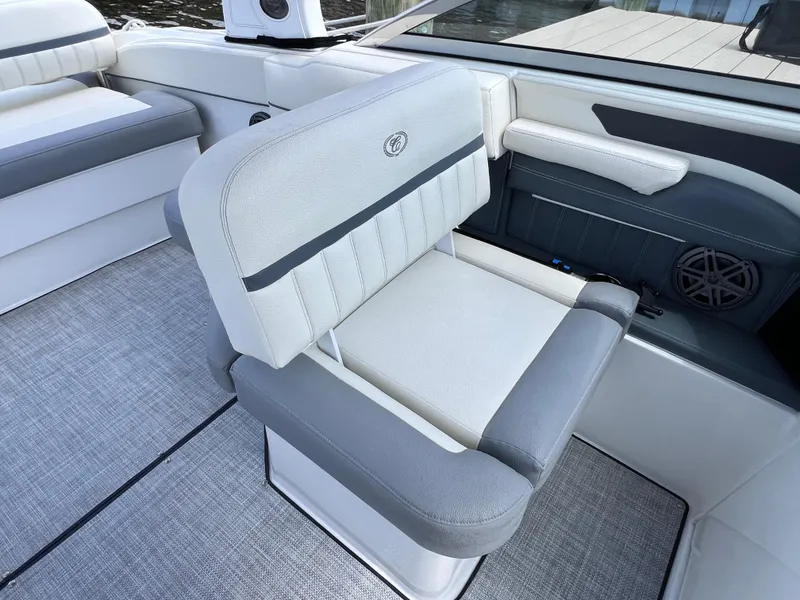 Slide: The Image of 2019 Cobalt 25 SC boat interior with gray and white seating, fresh water use. - 28