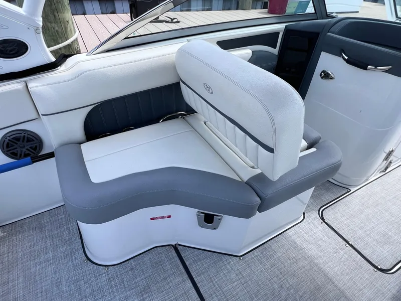 Slide: The Image of 2019 Cobalt 25 SC boat interior with gray and white seating, fresh water use. - 29