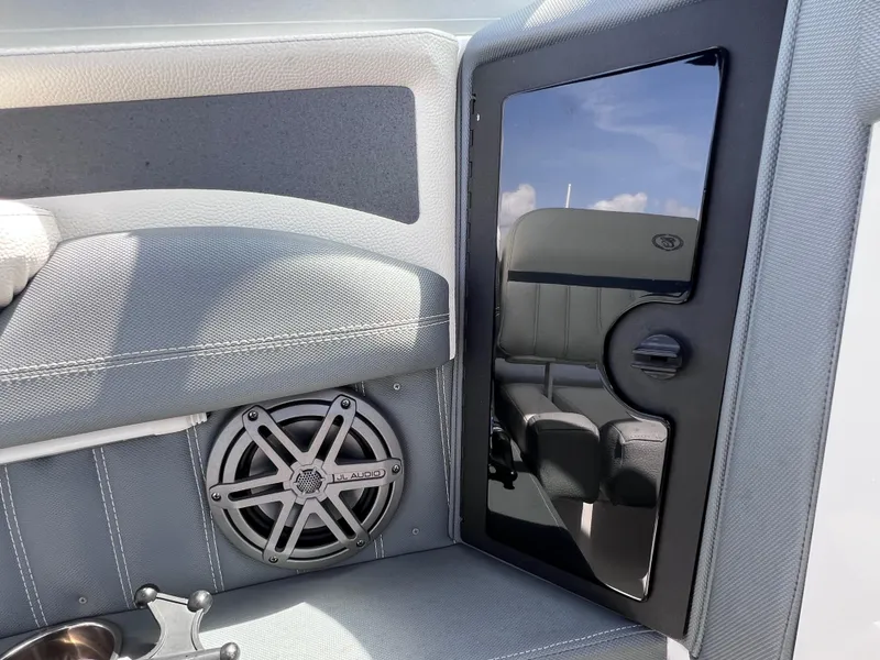 Slide: The Image of 2019 Cobalt 25 SC boat interior with speaker and reflective panel, fresh water use. - 32