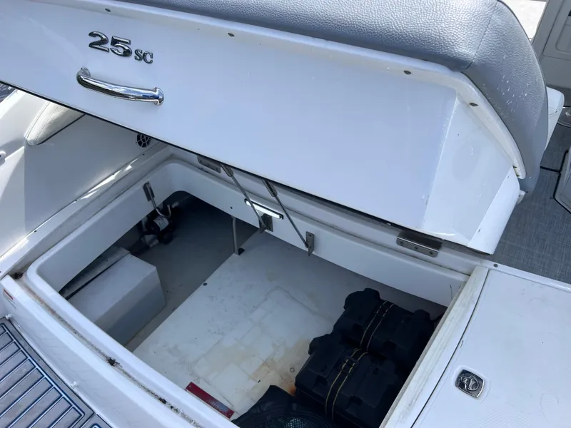 Slide: The Image of Open storage compartment in 2019 Cobalt 25 SC boat, showcasing interior space and design. - 46