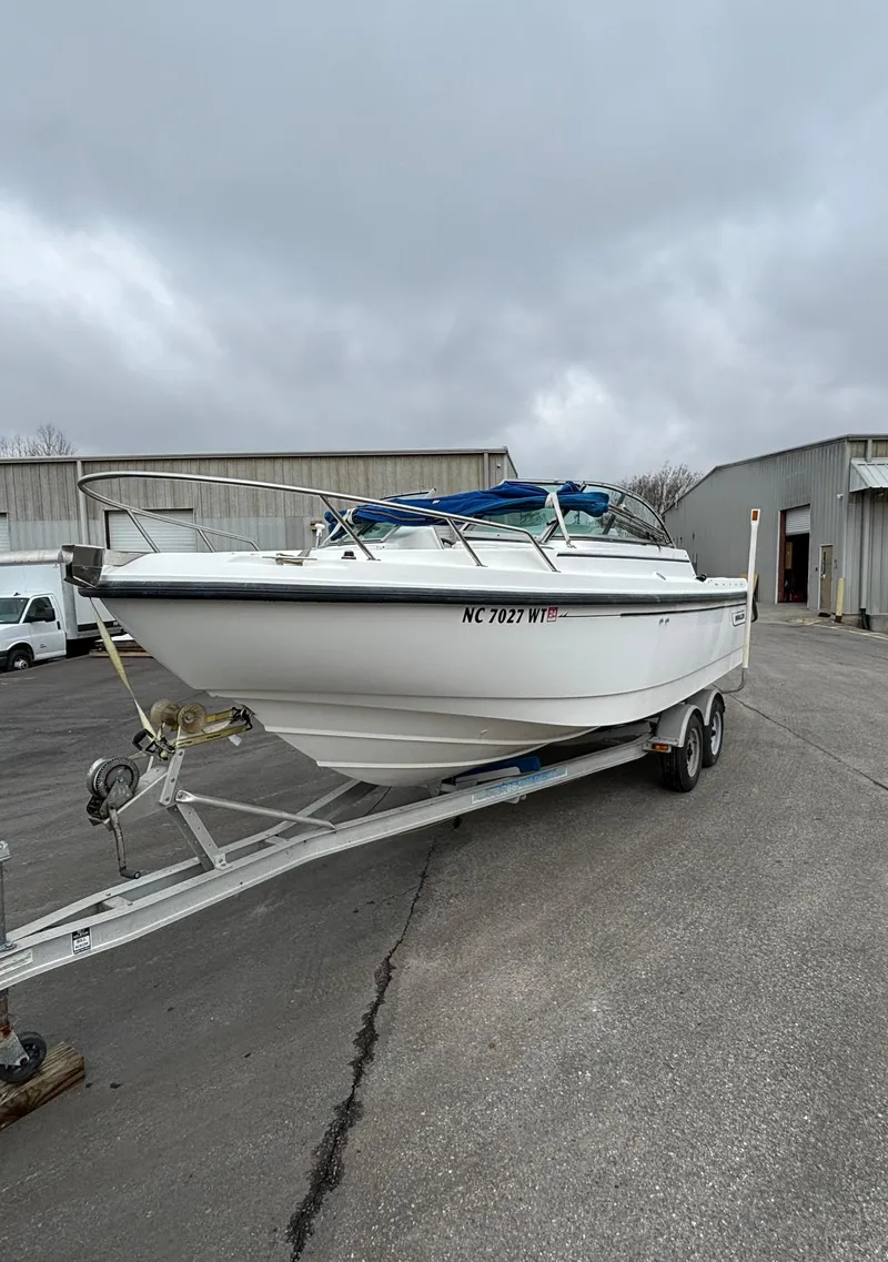 Slide: The Image of 2002 Boston Whaler 210 Ventura boat on trailer, parked outdoors. - 4
