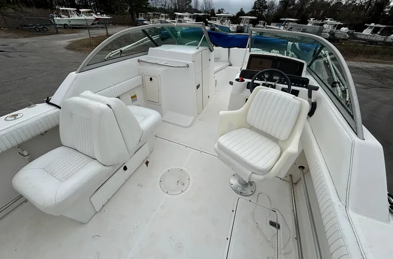 Slide: The Image of 2002 Boston Whaler 210 Ventura boat interior with white seating and steering console. - 5