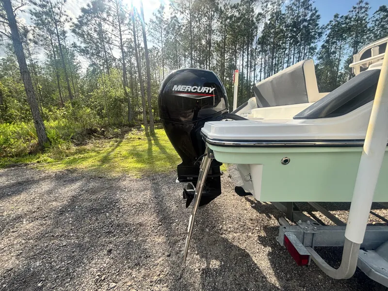 Slide: The Image of 2022 Bayliner Trophy T20CX boat with Mercury engine in a wooded area. - 10