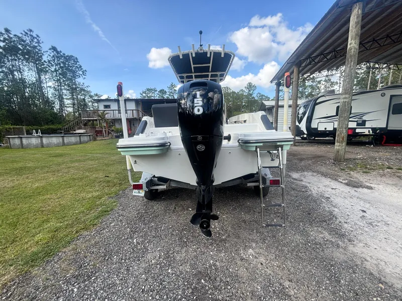 Slide: The Image of 2022 Bayliner Trophy T20CX boat with 150 HP engine, parked outdoors. - 11