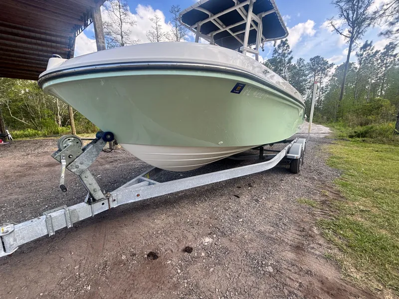 Slide: The Image of 2022 Bayliner Trophy T20CX boat on trailer, parked outdoors. - 2