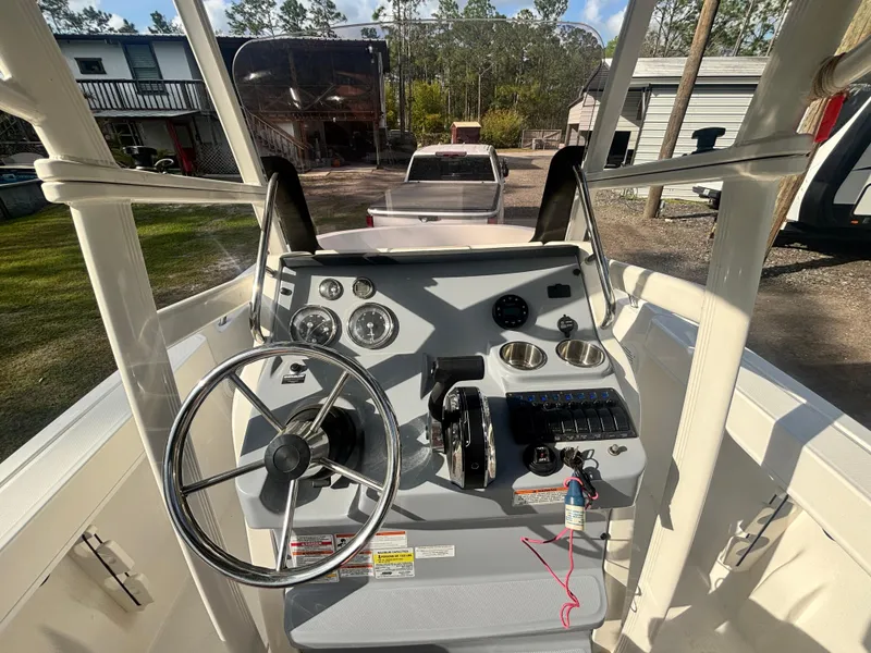 Slide: The Image of 2022 Bayliner Trophy T20CX boat dashboard with steering wheel and controls. - 20