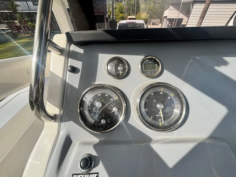 Slide: The Image of Dashboard of 2022 Bayliner Trophy T20CX boat with gauges and controls. - 22