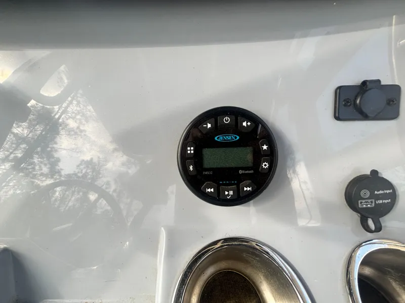 Slide: The Image of 2022 Bayliner Trophy T20CX dashboard with Jensen audio system and controls. - 23