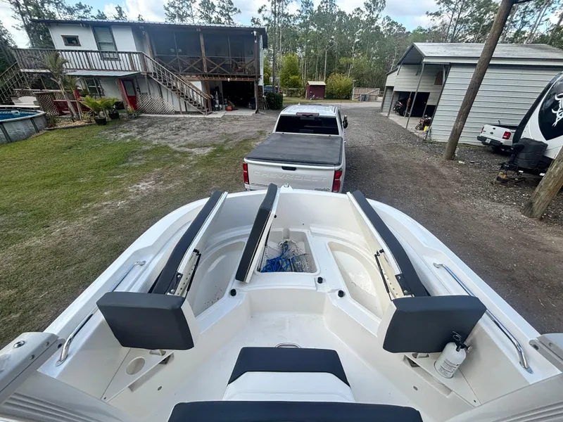 Slide: The Image of 2022 Bayliner Trophy T20CX boat on trailer, parked in a residential driveway. - 26