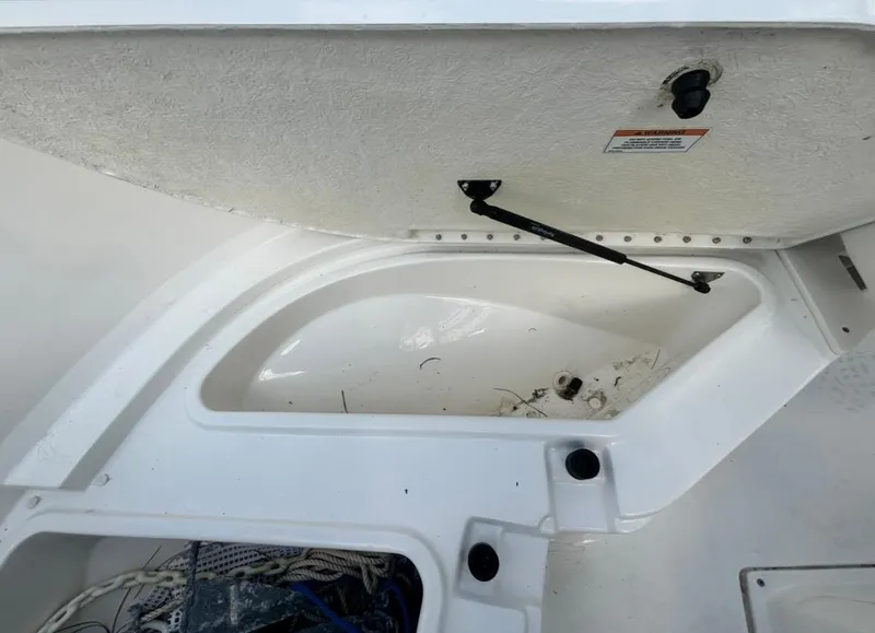 Slide: The Image of 2022 Bayliner Trophy T20CX storage compartment with open hatch, showcasing interior space. - 28