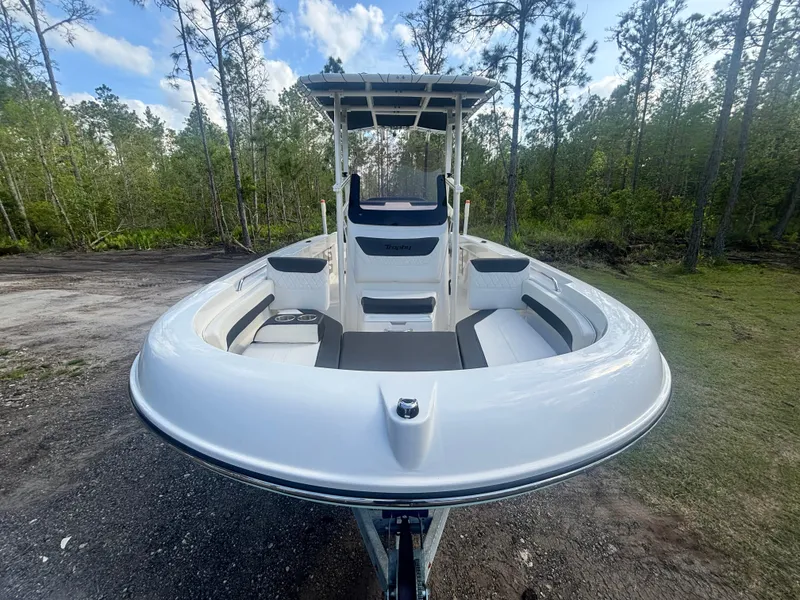 Slide: The Image of 2022 Bayliner Trophy T20CX boat on trailer, surrounded by trees and blue sky. - 3