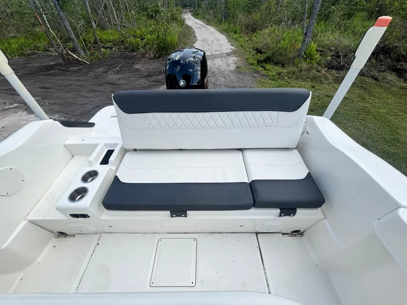 Slide: The Image of 2022 Bayliner Trophy T20CX boat interior with cushioned seating and cup holders. - 38