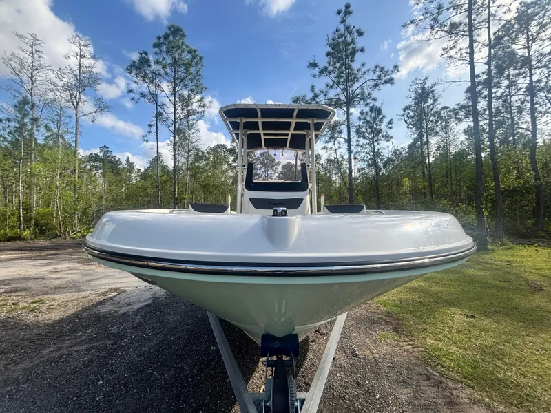 Slide: The Image of 2022 Bayliner Trophy T20CX boat on trailer, surrounded by trees and blue sky. - 4