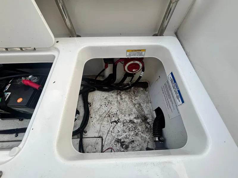 Slide: The Image of 2022 Bayliner Trophy T20CX boat storage compartment with battery and wiring. - 41