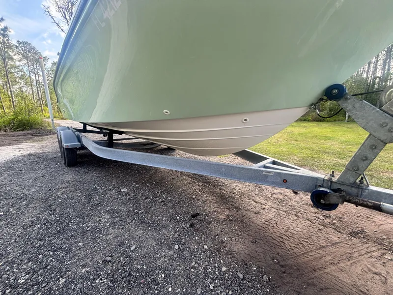 Slide: The Image of 2022 Bayliner Trophy T20CX boat on trailer, parked on gravel near trees. - 7