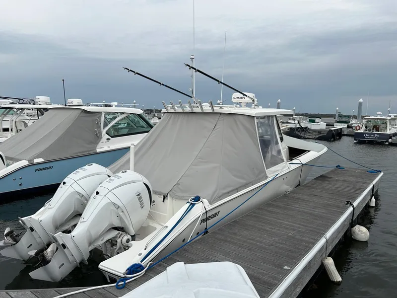 Slide: The Image of 2021 Pursuit S 328 Sport boat docked with twin outboard engines. - 14