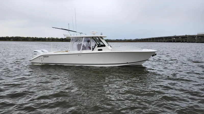 Slide: The Image of 2021 Pursuit S 328 Sport boat on calm water, side view. - 3