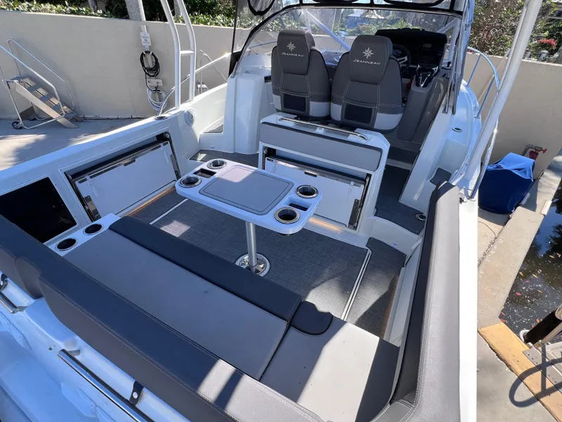 Slide: The Image of 2021 Jeanneau Leader 9.0 WA boat interior with seating and table setup. - 16