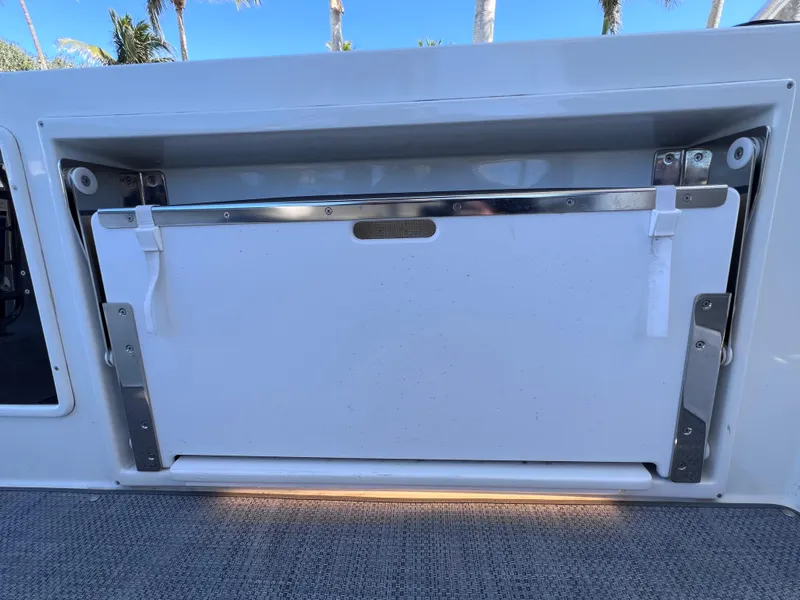 Slide: The Image of 2021 Jeanneau Leader 9.0 WA storage compartment with sleek design and stainless steel accents. - 20