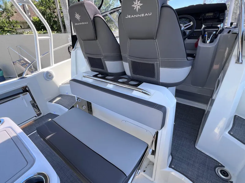Slide: The Image of 2021 Jeanneau Leader 9.0 WA boat interior with dual seats and modern controls. - 23