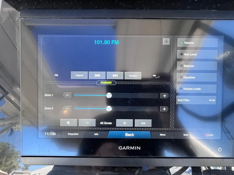 Slide: The Image of Garmin marine audio control display on Jeanneau Leader 9.0 WA, showing FM 101.90. - 31