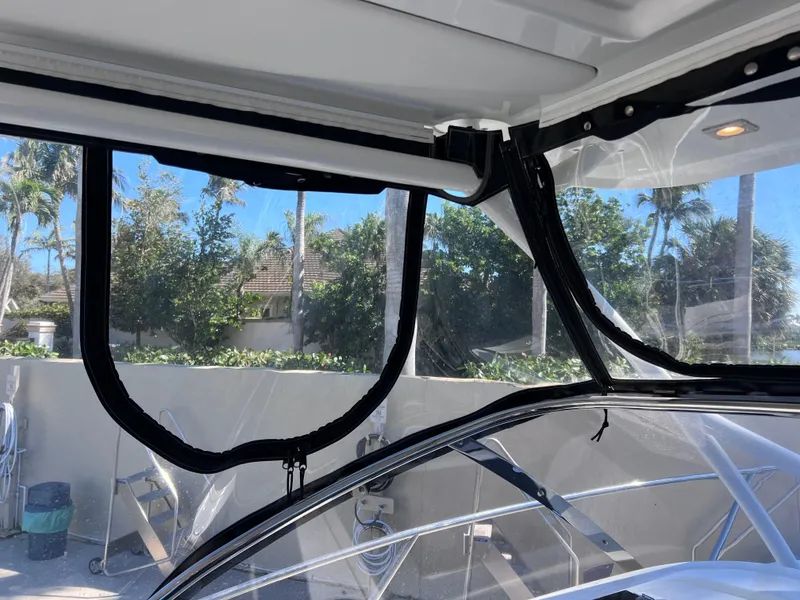 Slide: The Image of 2021 Jeanneau Leader 9.0 WA boat interior with clear enclosure and scenic outdoor view. - 40