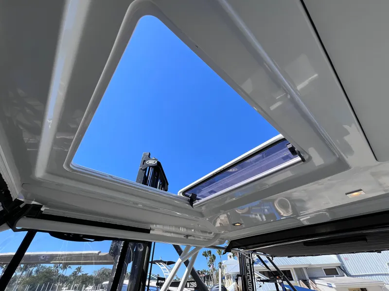 Slide: The Image of 2021 Jeanneau Leader 9.0 WA boat sunroof view with clear blue sky. - 42