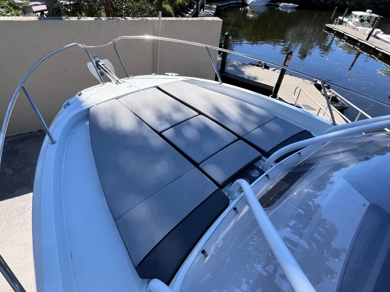 Slide: The Image of 2021 Jeanneau Leader 9.0 WA with sunpad, docked by a serene waterfront. - 43