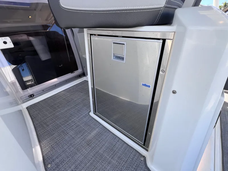 Slide: The Image of 2021 Jeanneau Leader 9.0 WA interior with compact stainless steel fridge. - 47