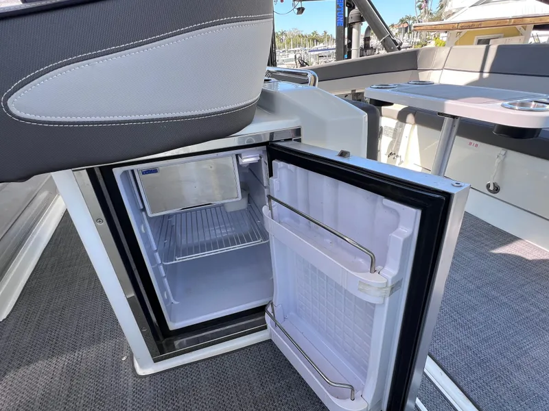 Slide: The Image of Open mini fridge on 2021 Jeanneau Leader 9.0 WA boat, showcasing interior storage space. - 48